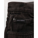 Dolce & Gabbana Black Cotton Tattered Denim Men Bermuda Short close-up with brand label and pocket detail.