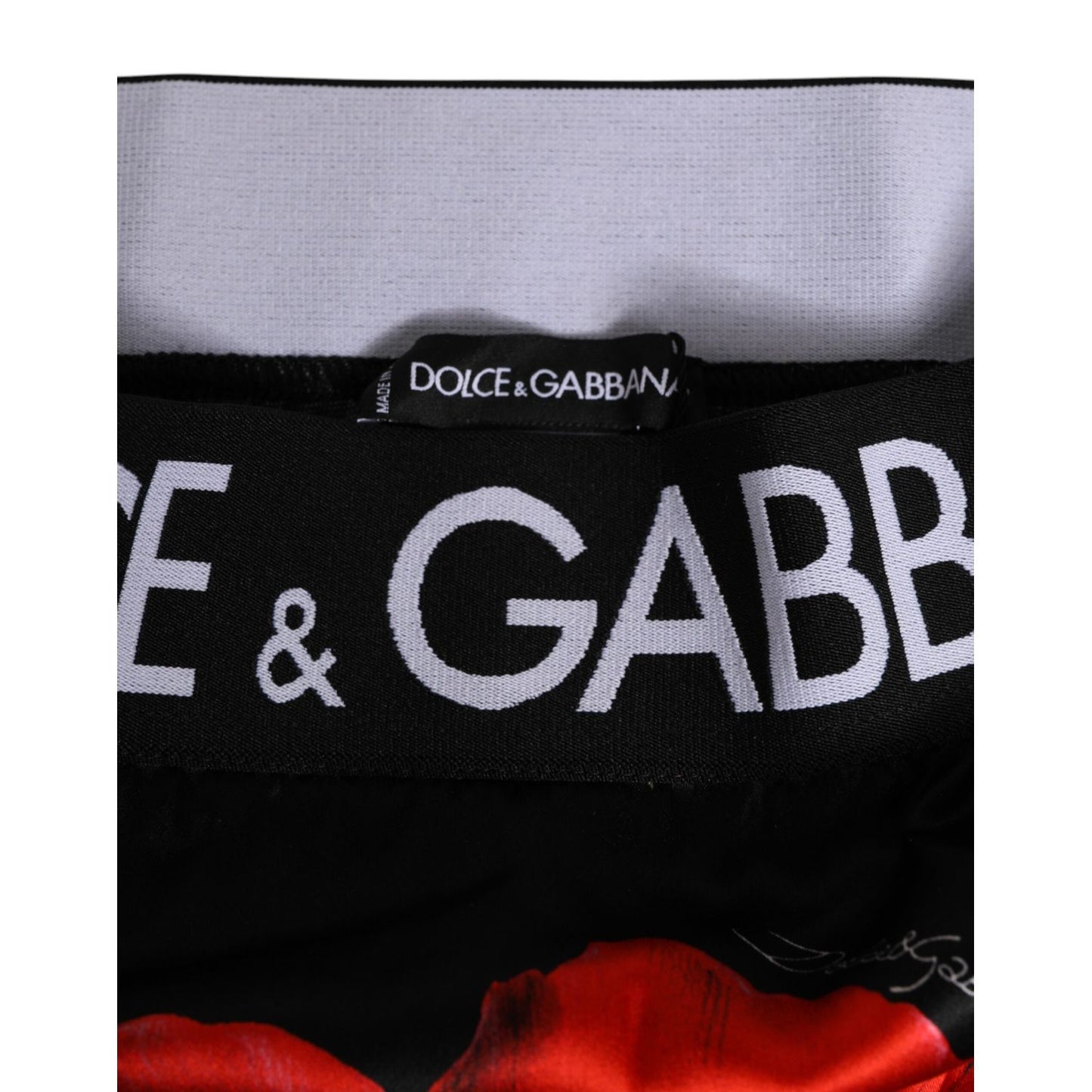 Close-up of Dolce & Gabbana Black Floral Print High Waist Sheer Mesh Underwear waistband with logo and red poppy design.