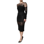 Woman wearing Dolce & Gabbana Black Lace Trim Nylon Tulle SheathMidi Dress, elegant black evening dress with intricate lace trim.