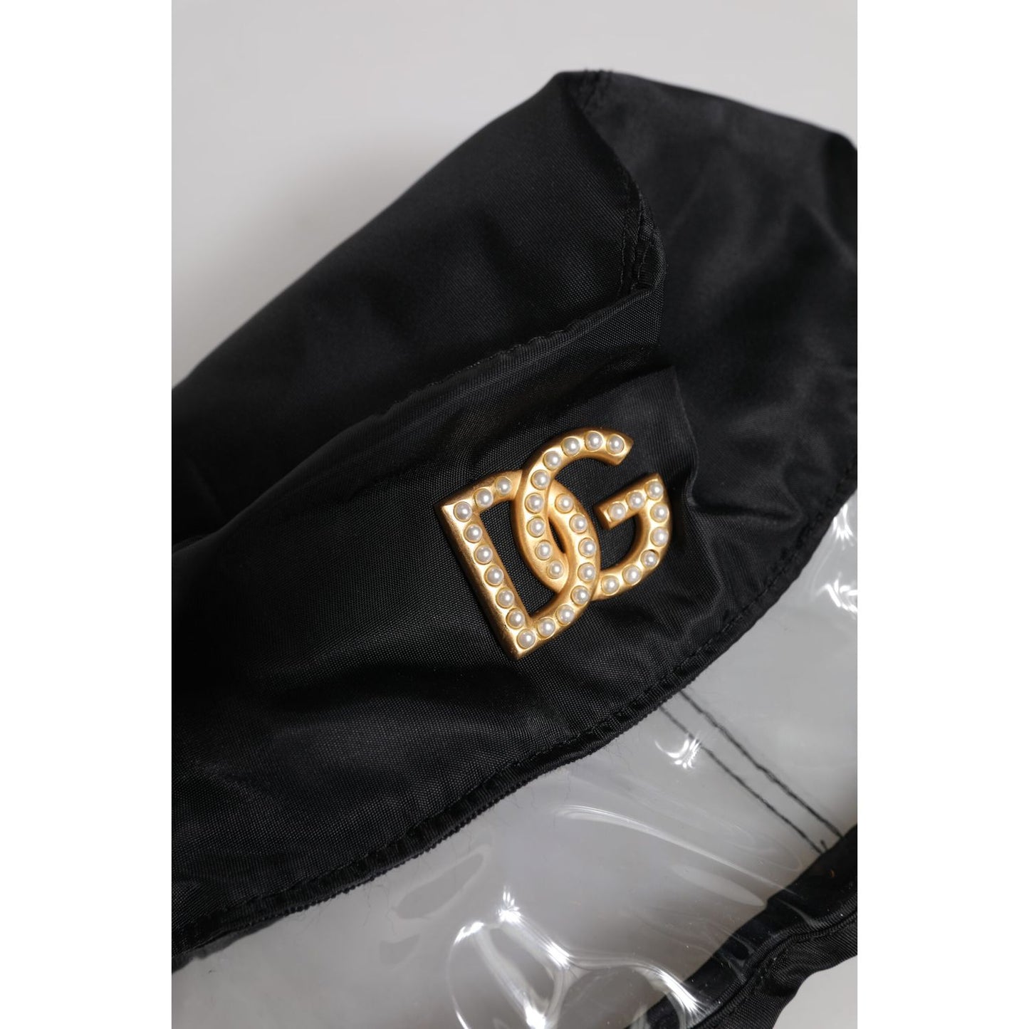 Dolce & Gabbana Black Nylon PVC DG Logo Bucket Hat with pearl-studded logo detail on brim, made in Italy. Stylish women's fashion accessory.