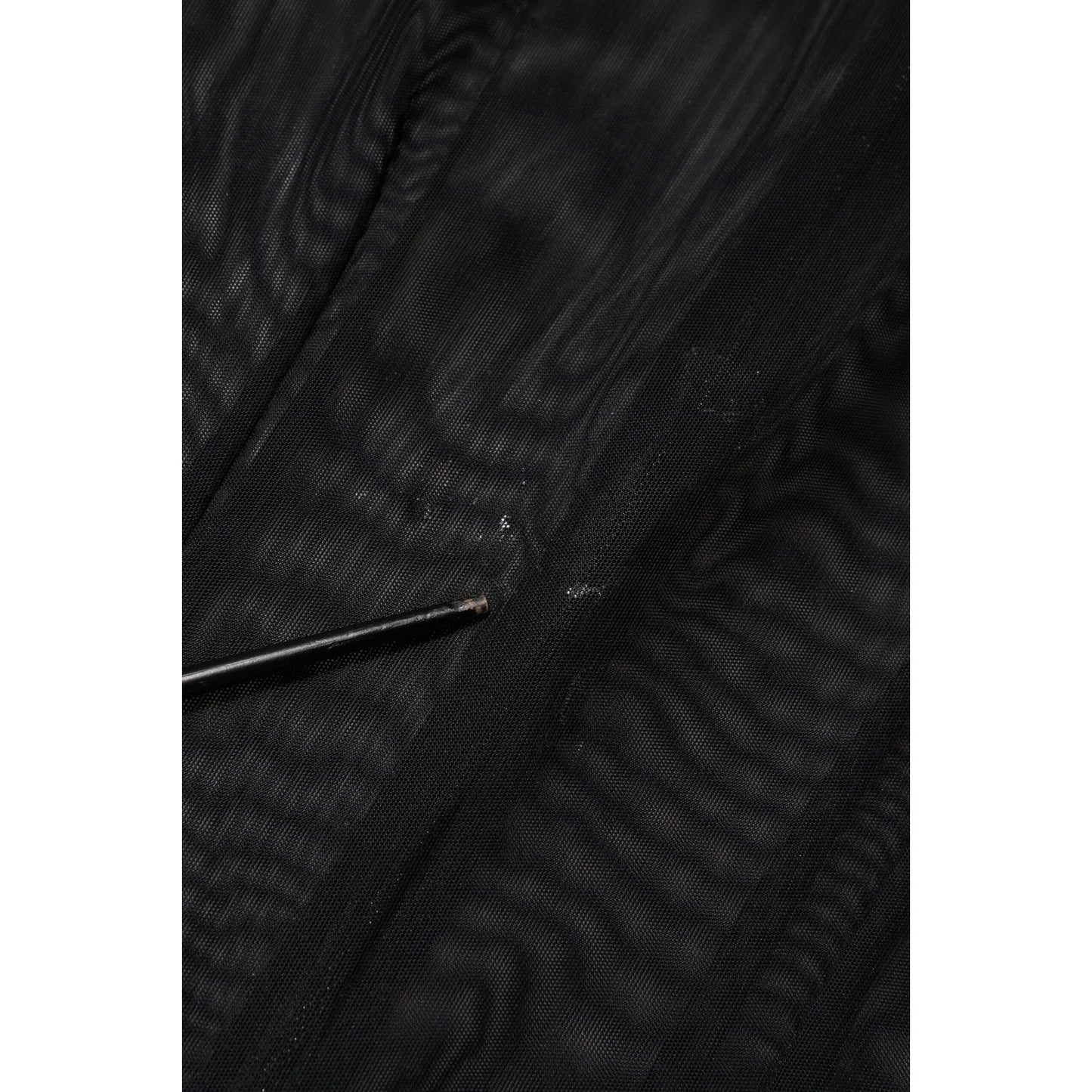 Close-up of Dolce & Gabbana Black Sheer Mesh Long Sleeve Jumpsuit Bodysuit Dress fabric detail.