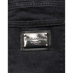 Close-up of Dolce & Gabbana Black Slim Fit Stretch Men Denim Pants Jeans label on black fabric.