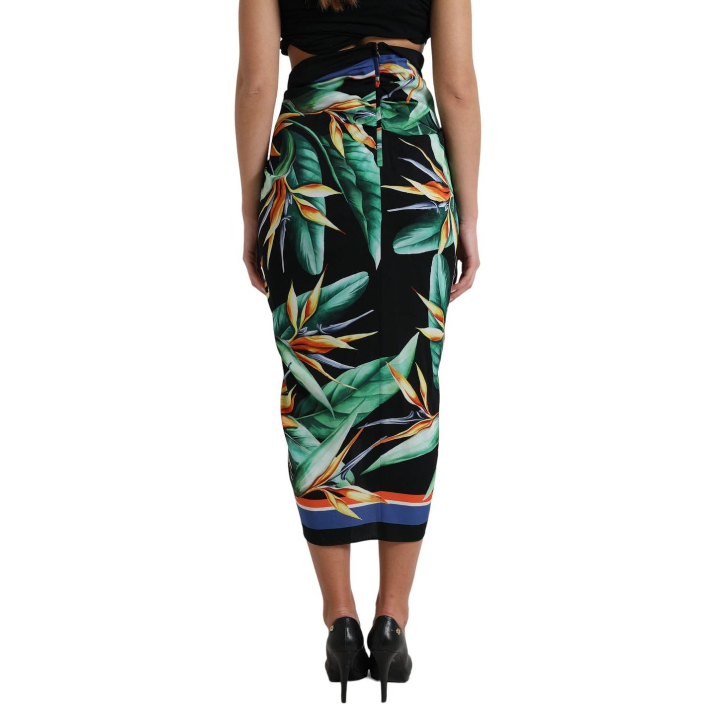 Back view of Dolce & Gabbana Black Strelitzia High Waist Wrap Midi Skirt with floral pattern and zipper closure, worn by model.