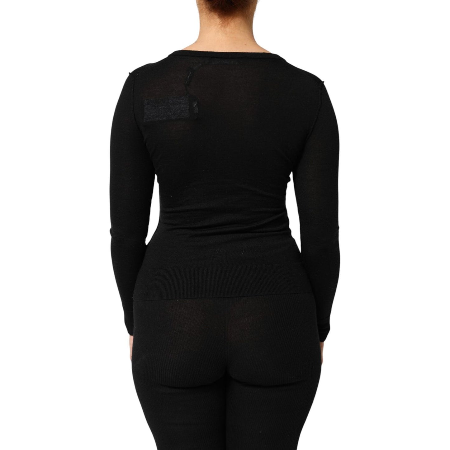 Back view of Dolce & Gabbana Black Virgin Wool Buttoned Cardigan Sweater showcasing ribbed design and elegant silhouette.