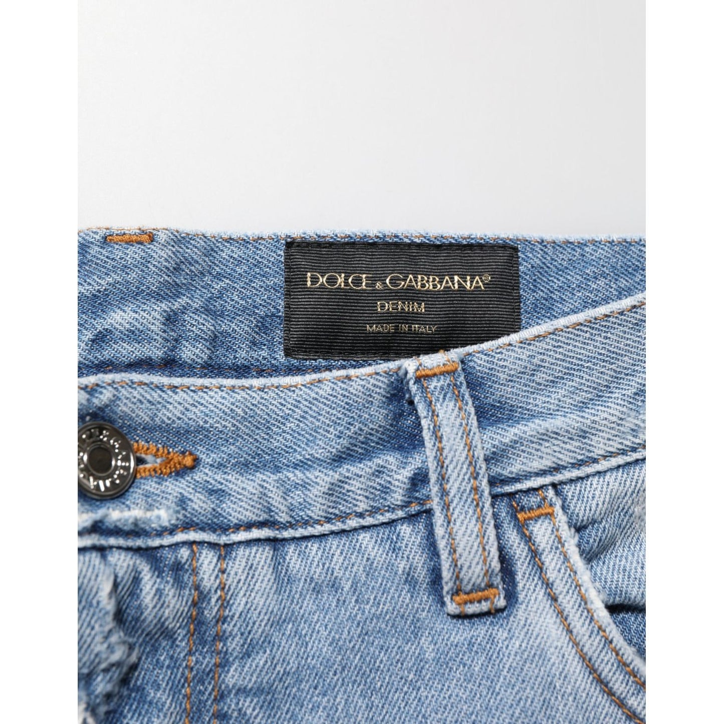 Dolce & Gabbana Blue Distressed Ripped Denim Pants Jeans with signature logo plaque on waistband, Italian-made premium cotton denim.