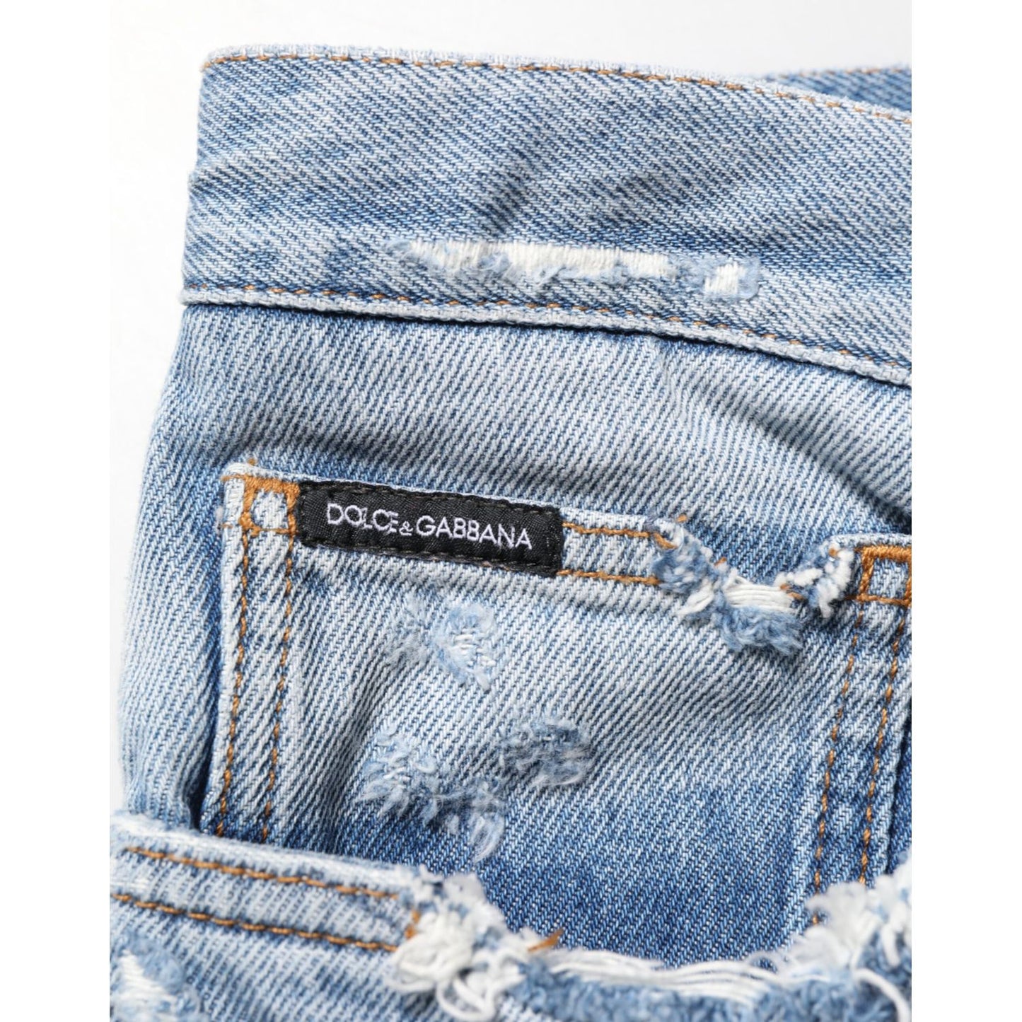 Dolce & Gabbana Blue Distressed Ripped Denim Pants Jeans with logo plaque detail, crafted in Italy with premium cotton.