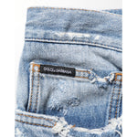 Dolce & Gabbana Blue Distressed Ripped Denim Pants Jeans with logo plaque detail, crafted in Italy with premium cotton.