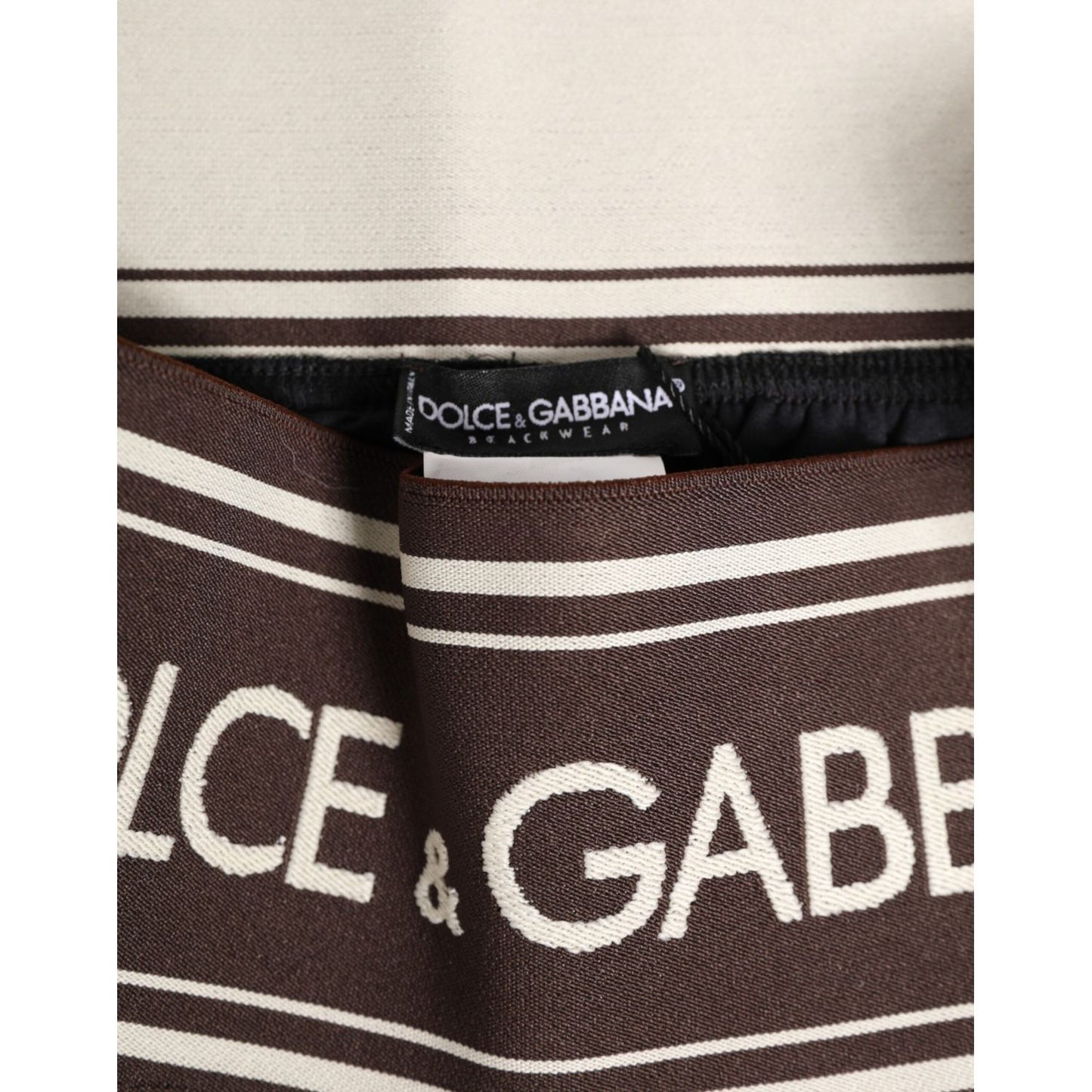 Close-up of Dolce & Gabbana Brown Polyester Logo Elastic Waistband Swimwear showcasing logo and elastic detail.