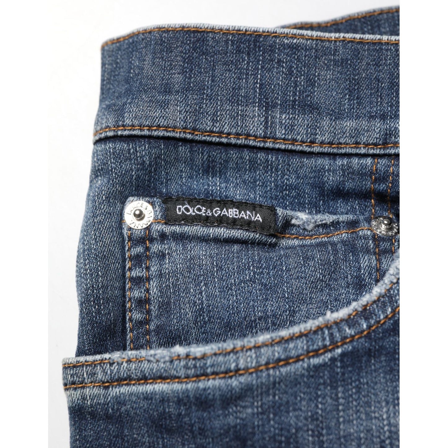 Close-up of Dolce & Gabbana Dark Blue Washed Running Ripped Denim Jeans pocket showcasing label and stitching.