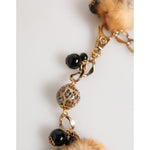 Close-up of Dolce & Gabbana Gold Black Crystals Lapin Fur Filigree Choker Necklace with leopard-print beads and pom-poms.
