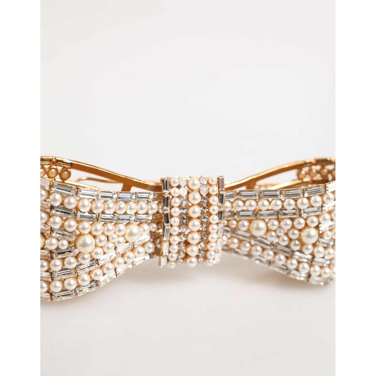 Dolce & Gabbana Gold Brass Glas Crystal Faux Pearl Embellished Brooch featuring a bow design with shimmering pearls and crystals.