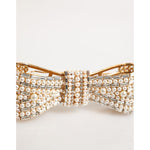 Dolce & Gabbana Gold Brass Glas Crystal Faux Pearl Embellished Brooch featuring a bow design with shimmering pearls and crystals.
