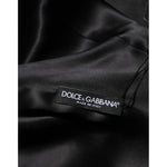 Close-up of Dolce & Gabbana label on the green viscose acetate mini long sleeve dress, showcasing quality craftsmanship from Italy.