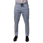Dolce & Gabbana Light Blue Cotton Drawstring Elastic Waist Men Pants, jogger style with slim fit and logo details.