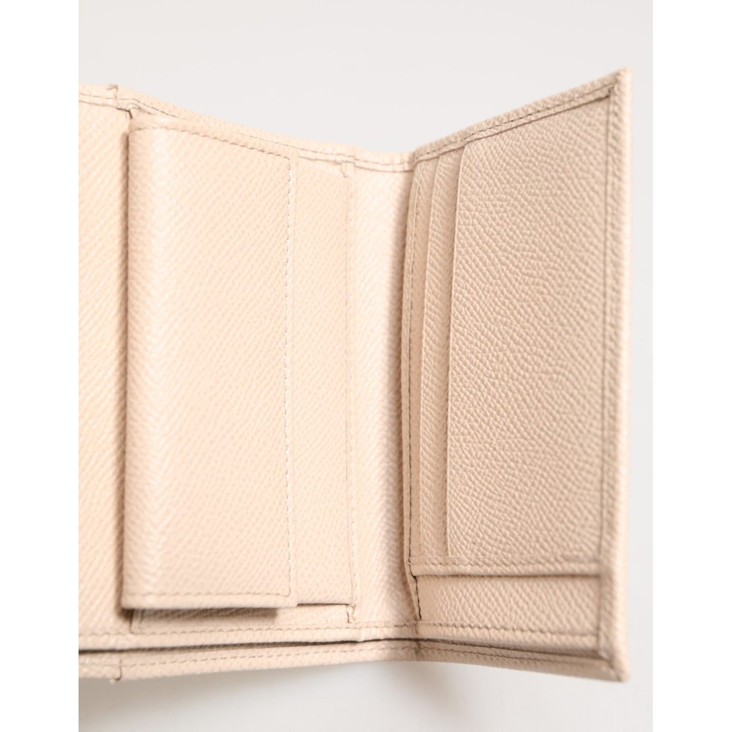 Interior of the Dolce & Gabbana Light Pink Calf Leather DG Logo French Flap Wallet showing compartments.