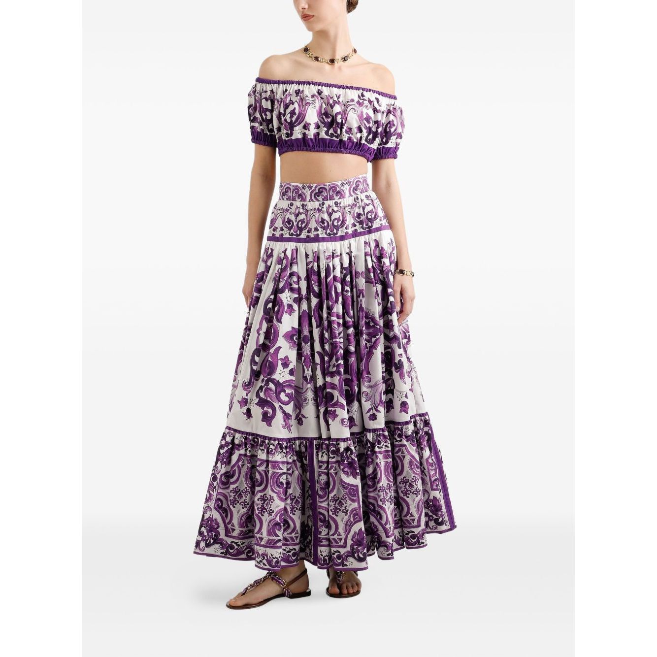 Woman wearing a Dolce & Gabbana Maiolica print cotton top with white off-shoulder short sleeves and elasticated trim.