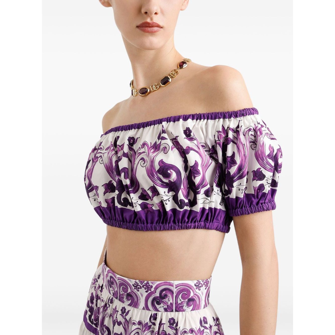 Dolce & Gabbana Maiolica print cotton top, white off-shoulder design with purple pattern and elasticated trim, worn by model