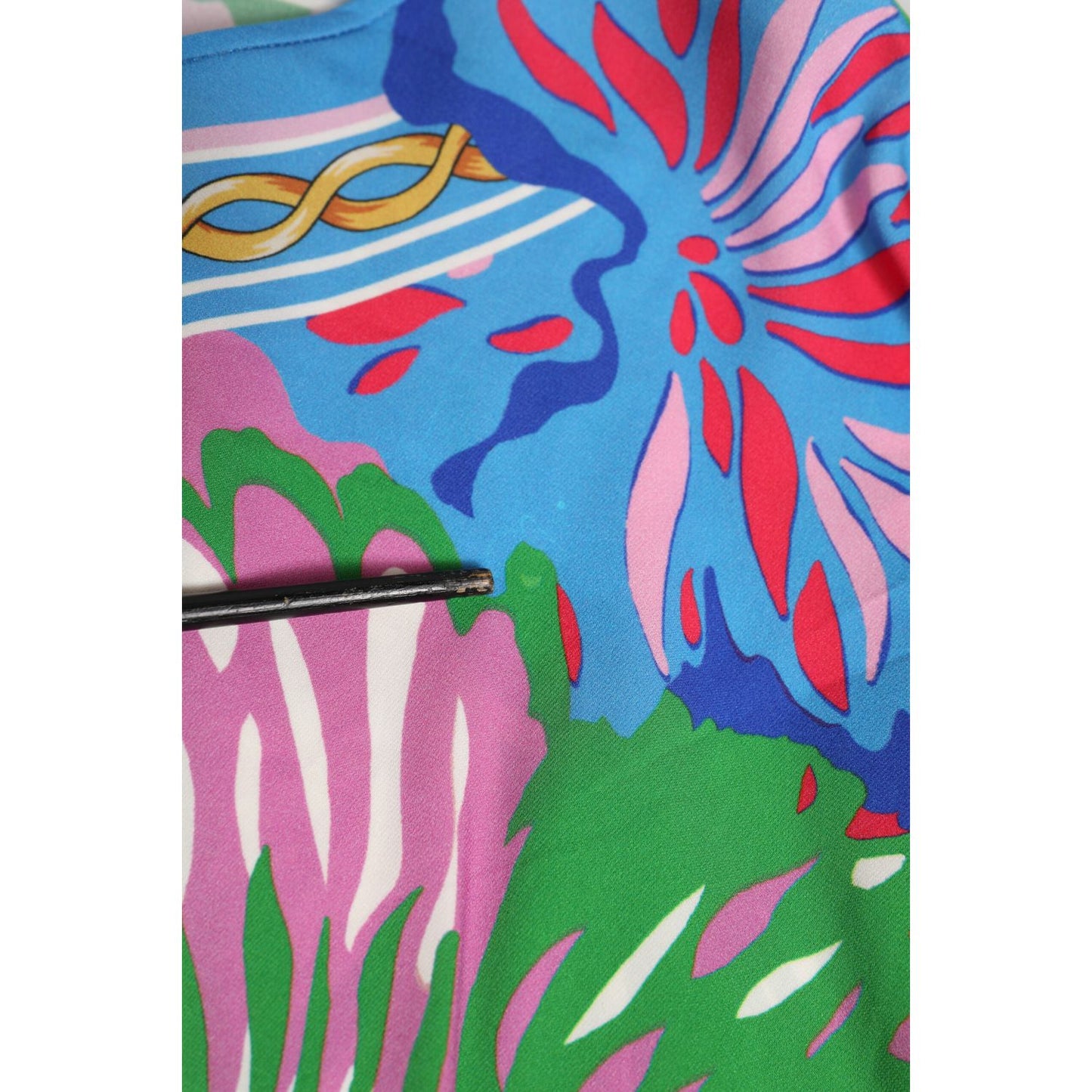 Dolce & Gabbana Multicolor Floral Printed Tunic Blouse Top fabric close-up showcasing vibrant floral patterns and colors.