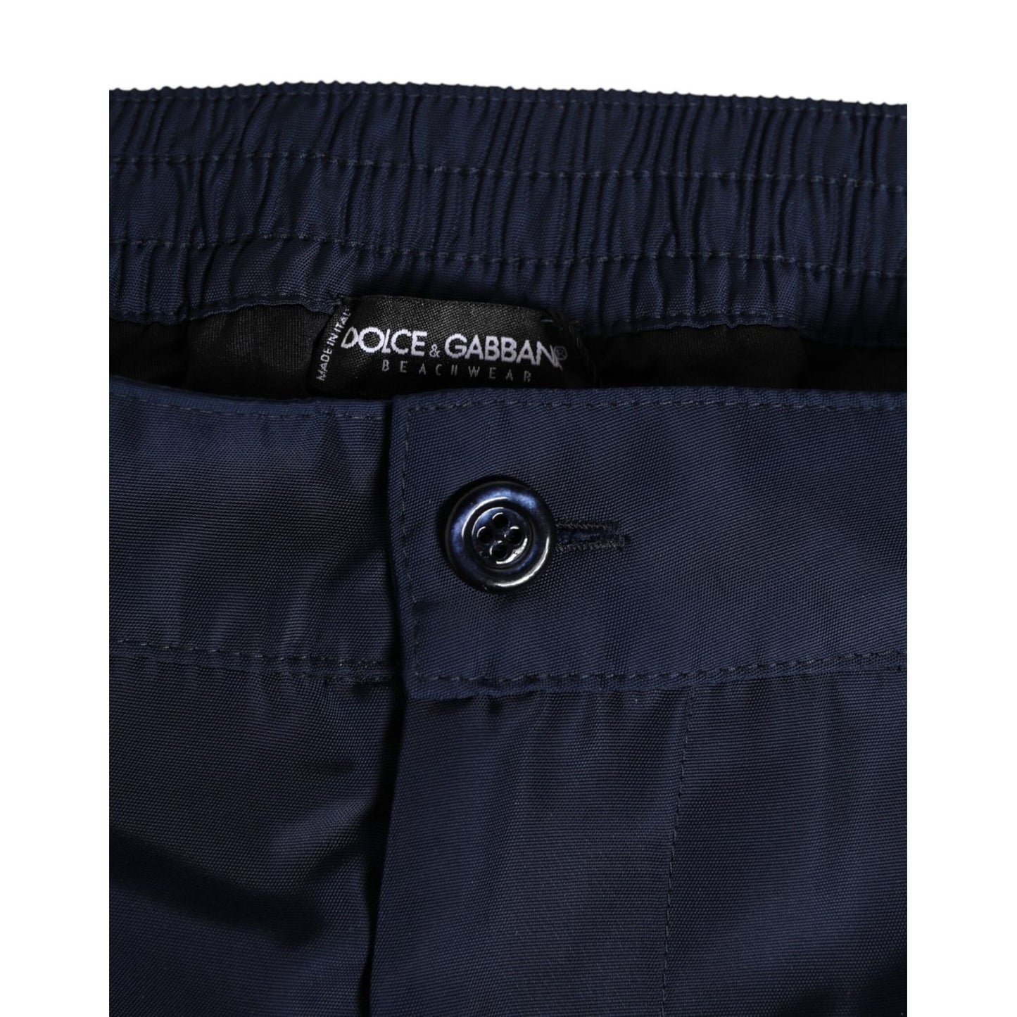 Close-up of Dolce & Gabbana Navy Blue Polyester Logo Buckle Waist Swimwear showcasing button detail and fabric texture.