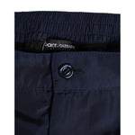 Close-up of Dolce & Gabbana Navy Blue Polyester Logo Buckle Waist Swimwear showcasing button detail and fabric texture.