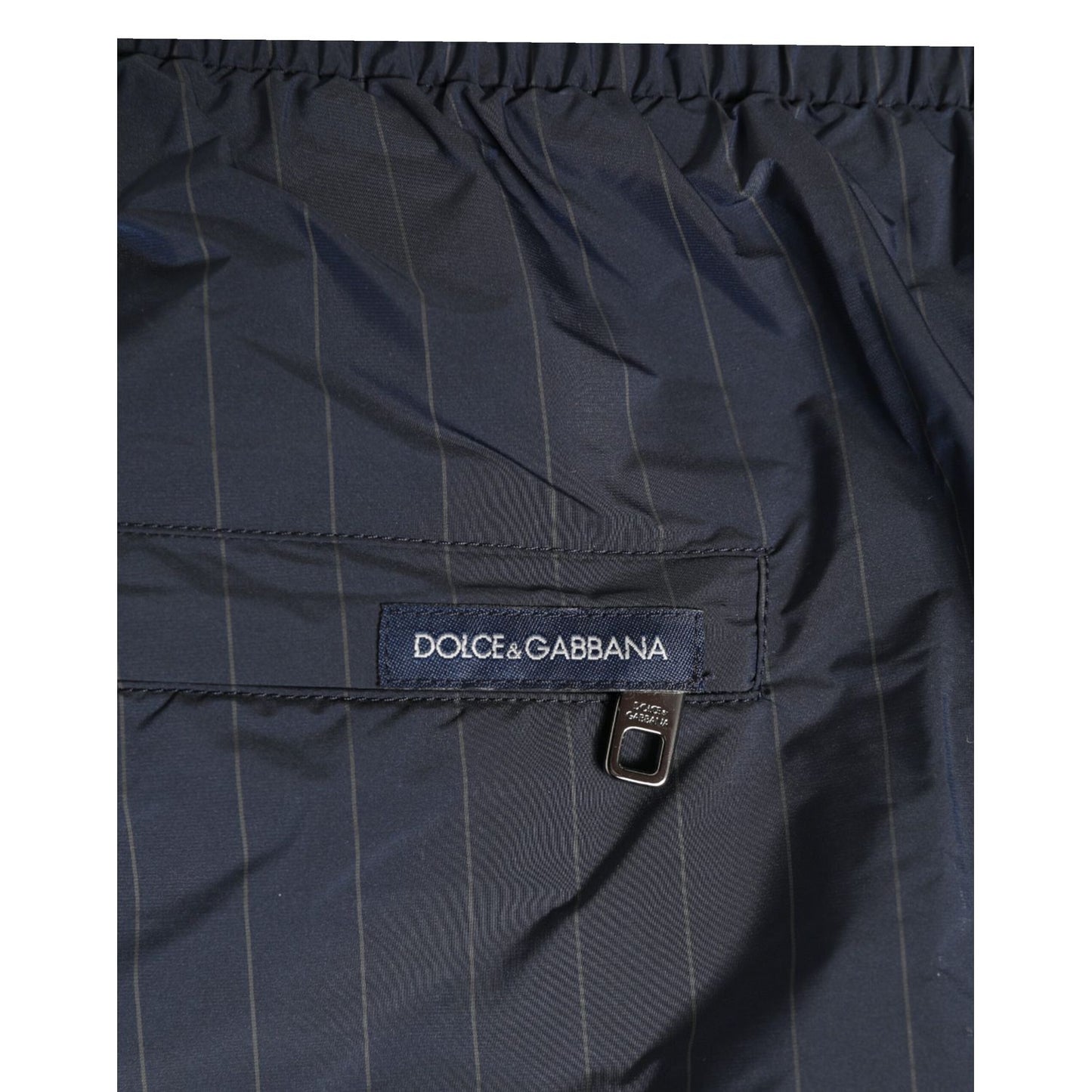 Close-up of Dolce & Gabbana Navy Blue Polyester Nylon Pinstripe Men's Swimwear with logo detailing and elastic waistband.