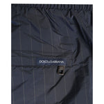 Close-up of Dolce & Gabbana Navy Blue Polyester Nylon Pinstripe Men's Swimwear with logo detailing and elastic waistband.