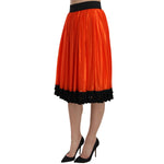Dolce & Gabbana Orange High Waist Knee Length Skirt, black trim, 84% Nylon and 16% Silk, made in Italy, zipper closure, elegant design.