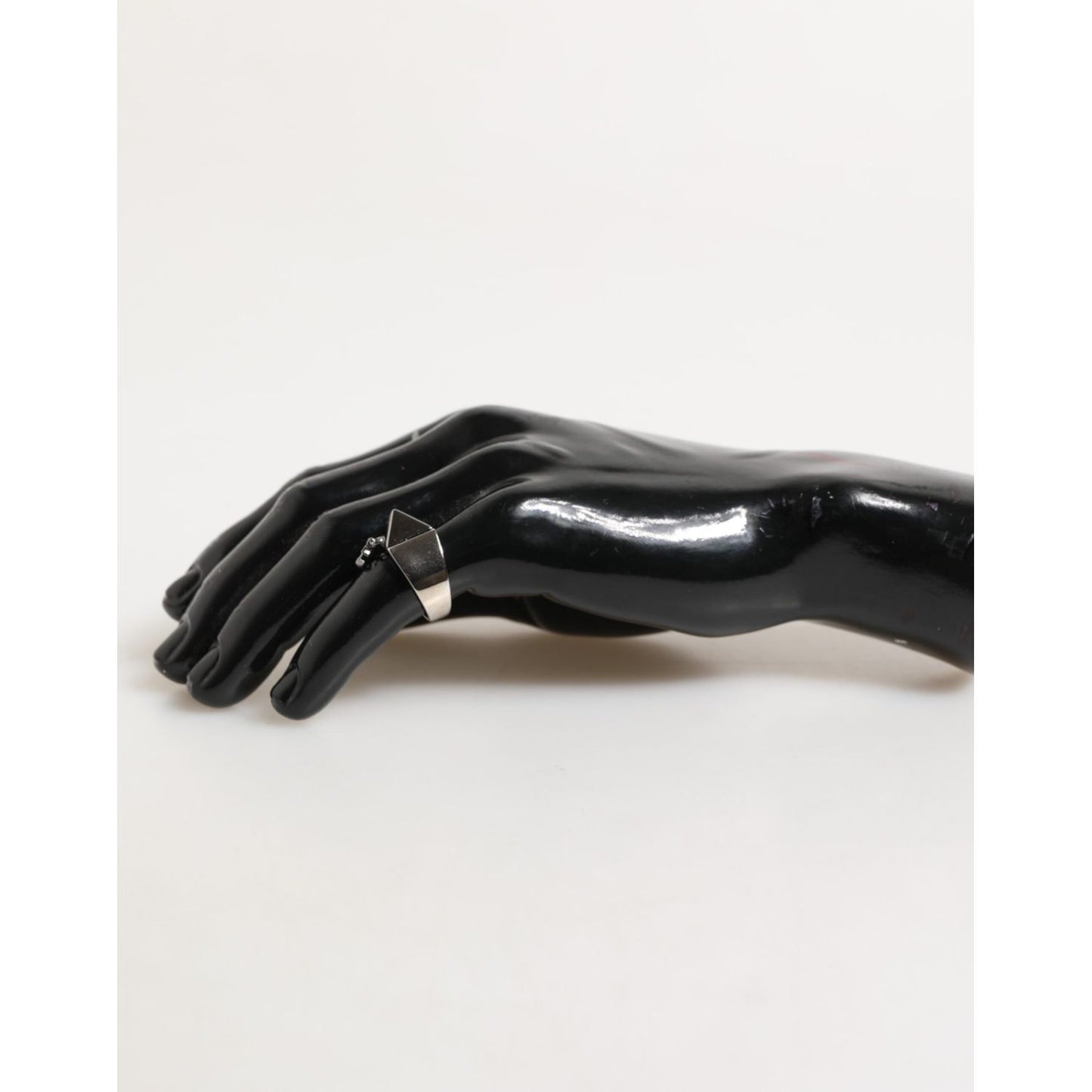 Dolce & Gabbana Silver Tone Pyramid DG Logo Real Brass Ring displayed on a mannequin hand.