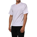 Dolce & Gabbana White Angel Print Cotton Men Crew Neck T-shirt with classic design, modeled for showcasing elegant casual wear.