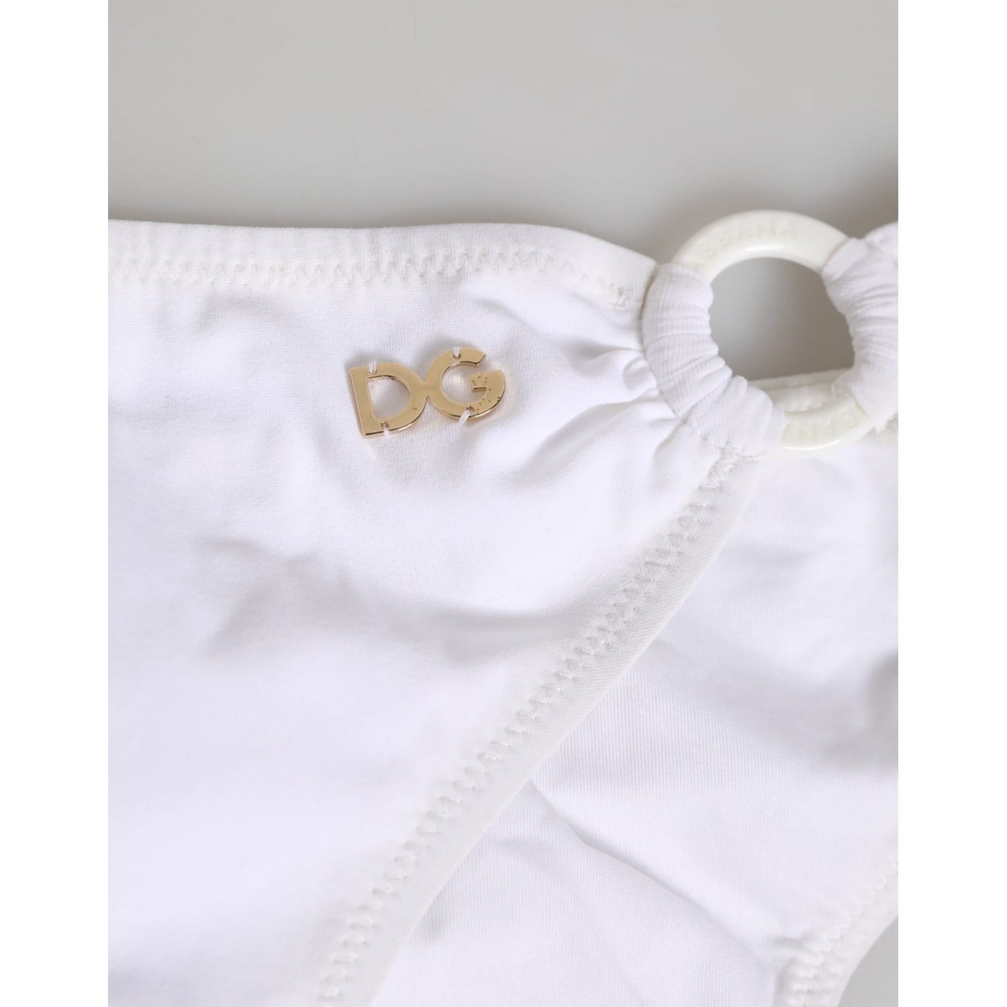 Close-up of Dolce & Gabbana White Logo Swimsuit 2 Piece Top Bottom Swimwear with logo detail on white fabric.