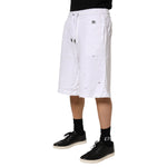 Dolce & Gabbana White Ripped Mid Waist Casual Bermuda Short shown with black sneakers and socks.