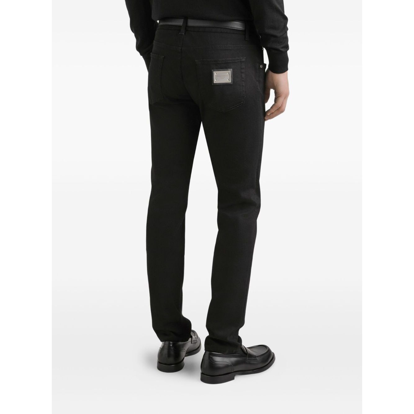 Back view of Dolce & Gabbana five pockets logo plaque Denim cotton jeans in black with classic fit, showing logo plaque on pocket.
