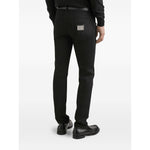 Back view of Dolce & Gabbana five pockets logo plaque Denim cotton jeans in black with classic fit, showing logo plaque on pocket.