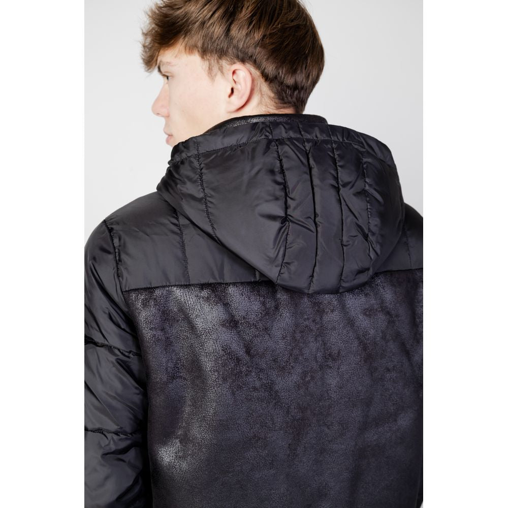 Rear view of model wearing EA7 Emporio Armani Black Polyester Shell Jacket, showcasing water-resistant hood and stylish design