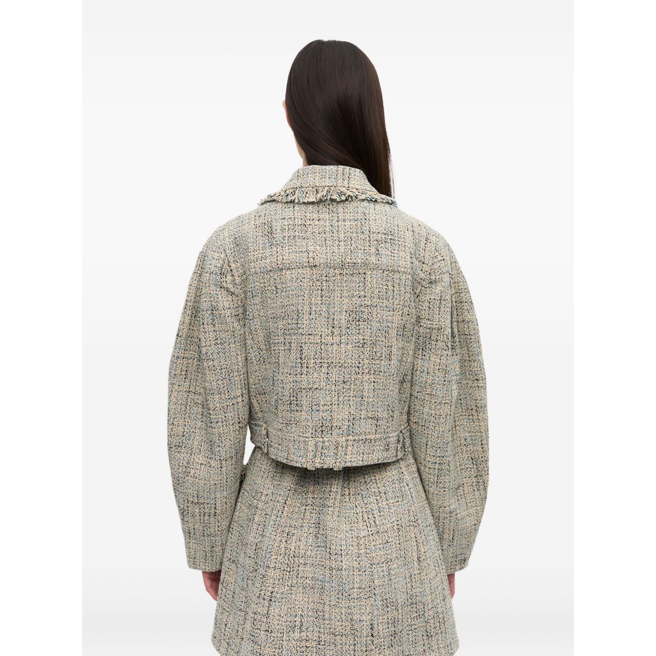 Back view of model wearing GANNI Jackets Beige, featuring pointed flat collar and frayed detailing in light beige tweed fabric.
