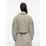 Back view of model wearing GANNI Jackets Beige, featuring pointed flat collar and frayed detailing in light beige tweed fabric.