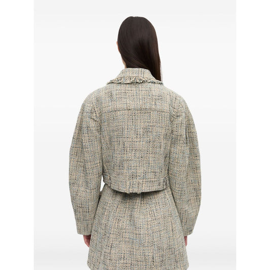 Back view of model wearing GANNI Jackets Beige, featuring pointed flat collar and frayed detailing in light beige tweed fabric.