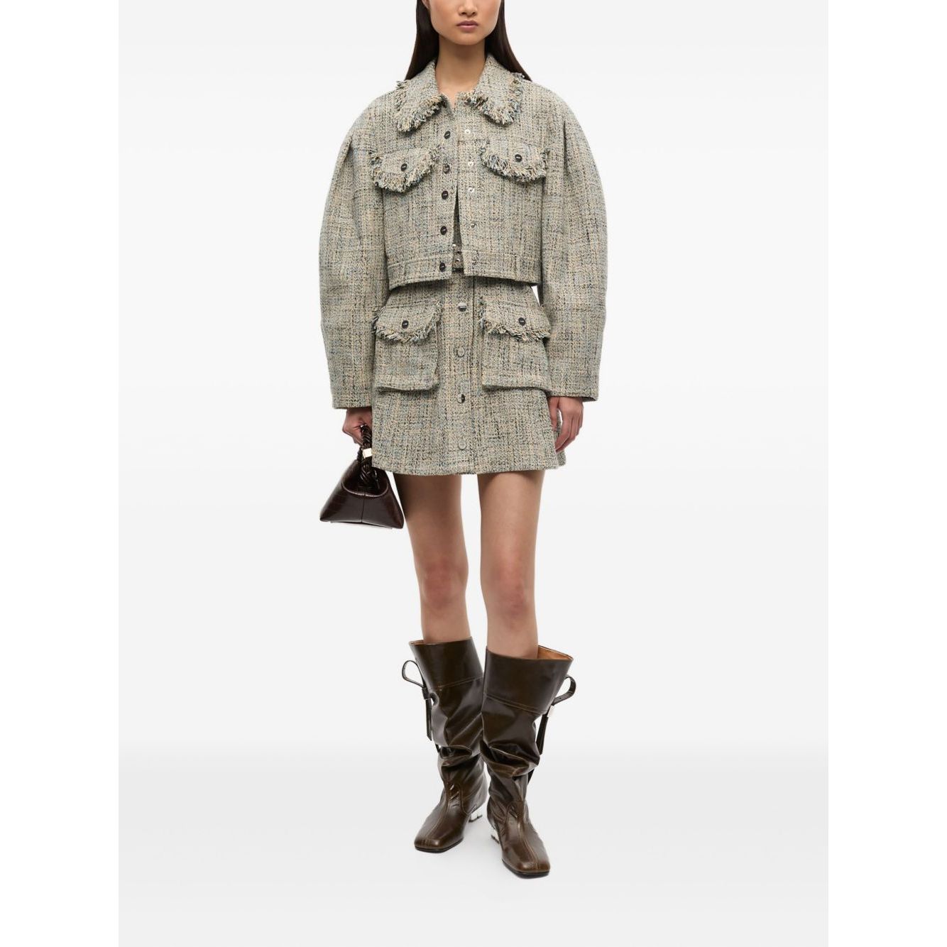 Model wearing GANNI Jackets Beige, light tweed with front button fastening, two chest pockets, frayed detailing, and pointed collar.