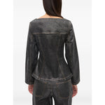 Back view of GANNI Jackets Black, denim cotton blazer with peplum waist and chest flap pockets, showcasing stylish design.