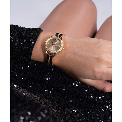 GUESS Mod. BELLINI women's watch in IP Gold SS, 30mm case, quartz movement, on wrist with black sequined dress.