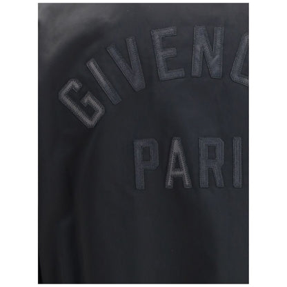 Close-up of Givenchy Black Cotton Bomber featuring leather GIVENCHY Paris logo appliqué on satin material.
