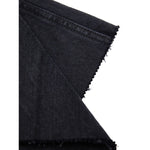 Close-up of Gucci Black Cotton Jeans Denim fabric showing texture and detailing.