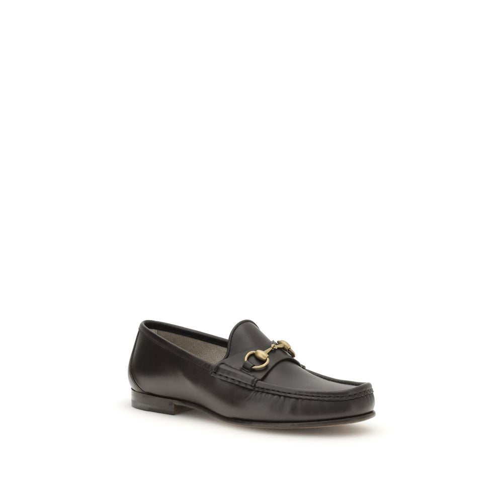 Gucci Brown Calf Leather Bos Taurus Slip-On Loafers with Horsebit detail and gold-tone hardware on a refined leather sole.