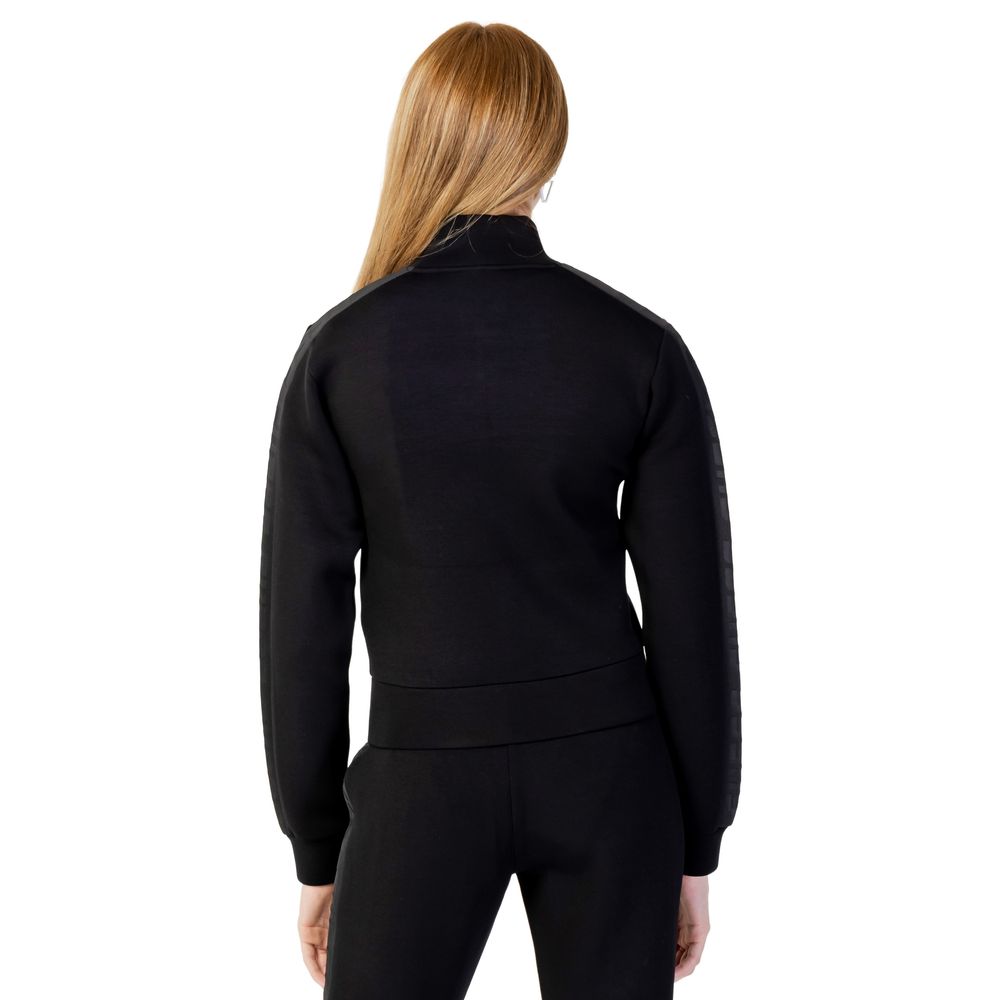 Back view of Guess Active Black Viscose Sweatshirt worn by model, showcasing sleek design and comfortable fit for daily activities.