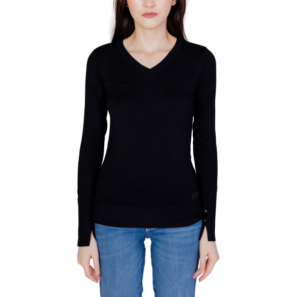 Woman wearing Guess Black Cotton Sweatshirt with V-neck and buttoned sleeves, paired with blue jeans, showcasing elegant and casual style.