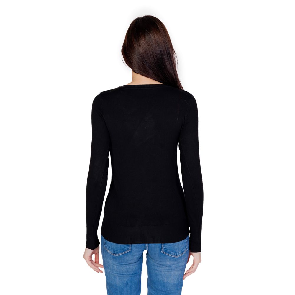 Back view of woman wearing Guess Black Cotton Sweatshirt with jeans, highlighting the fitted design and V-neck for versatile styling.