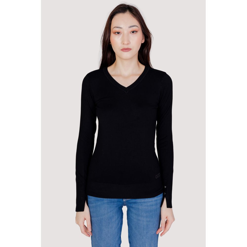 Woman wearing Guess Black Cotton Sweatshirt with V-neck and decorative button sleeves, styled with jeans.