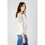 Model wearing Guess White Viscose Sportswear sweater with batwing sleeves and subtle logo detail.