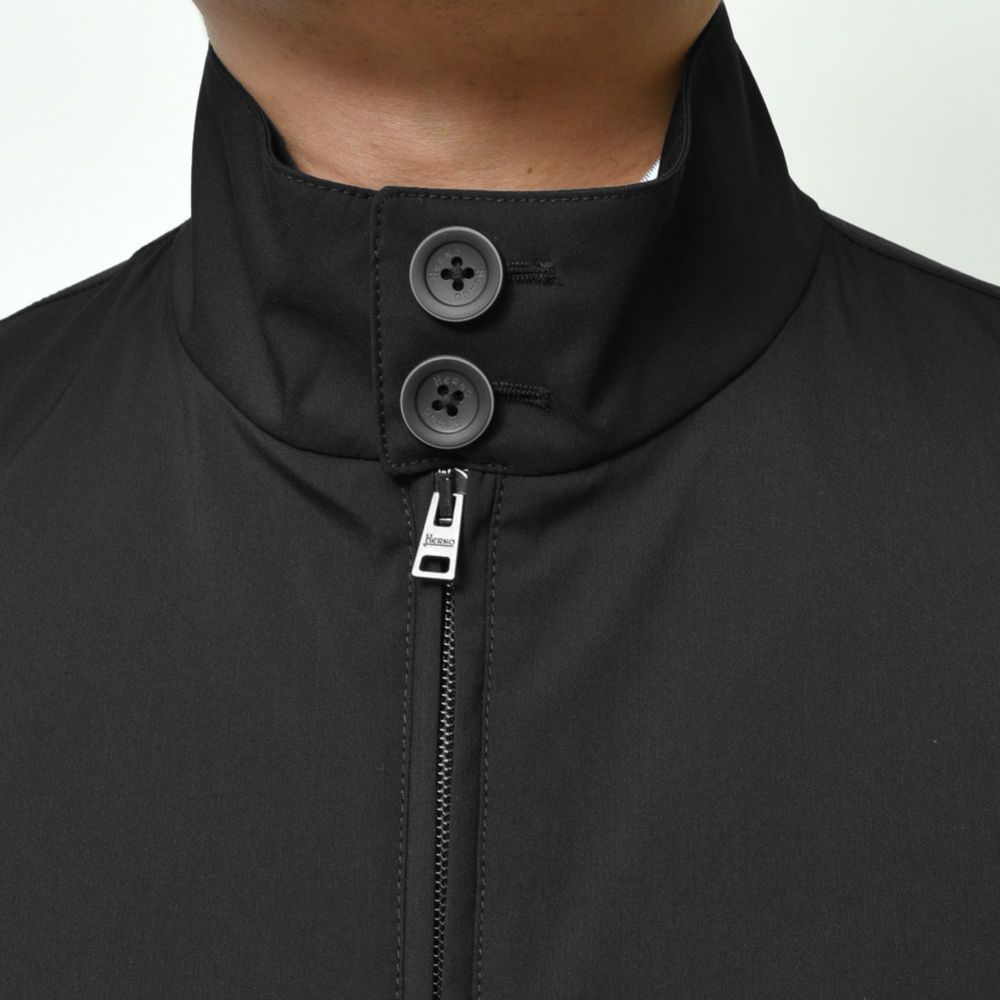 Herno Black Wool Jacket with high collar, double-slider zip, and double buttons in Loro Piana fabric, front view detail.