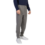 Man wearing Hugo Boss Gray Cotton Joggers Workout Pant with elastic waistband, drawstrings, and ribbed cuffs for flexible fit.